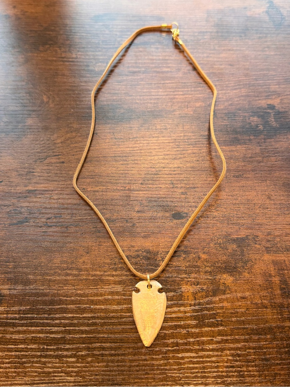 Brass Arrowhead Pendant Necklace on 24ā Brown Suede Cord